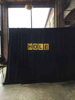 Black curtain yellow word Hole 