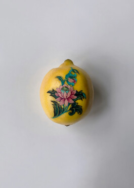 Pink lotus tattoo on a lemon
