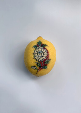 White flower tattooed on a lemon