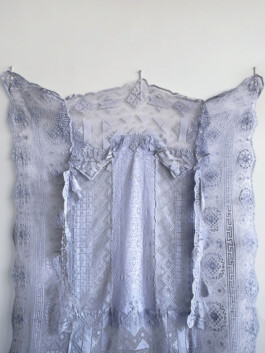 Detail of blue painted lace textile wall artwork 